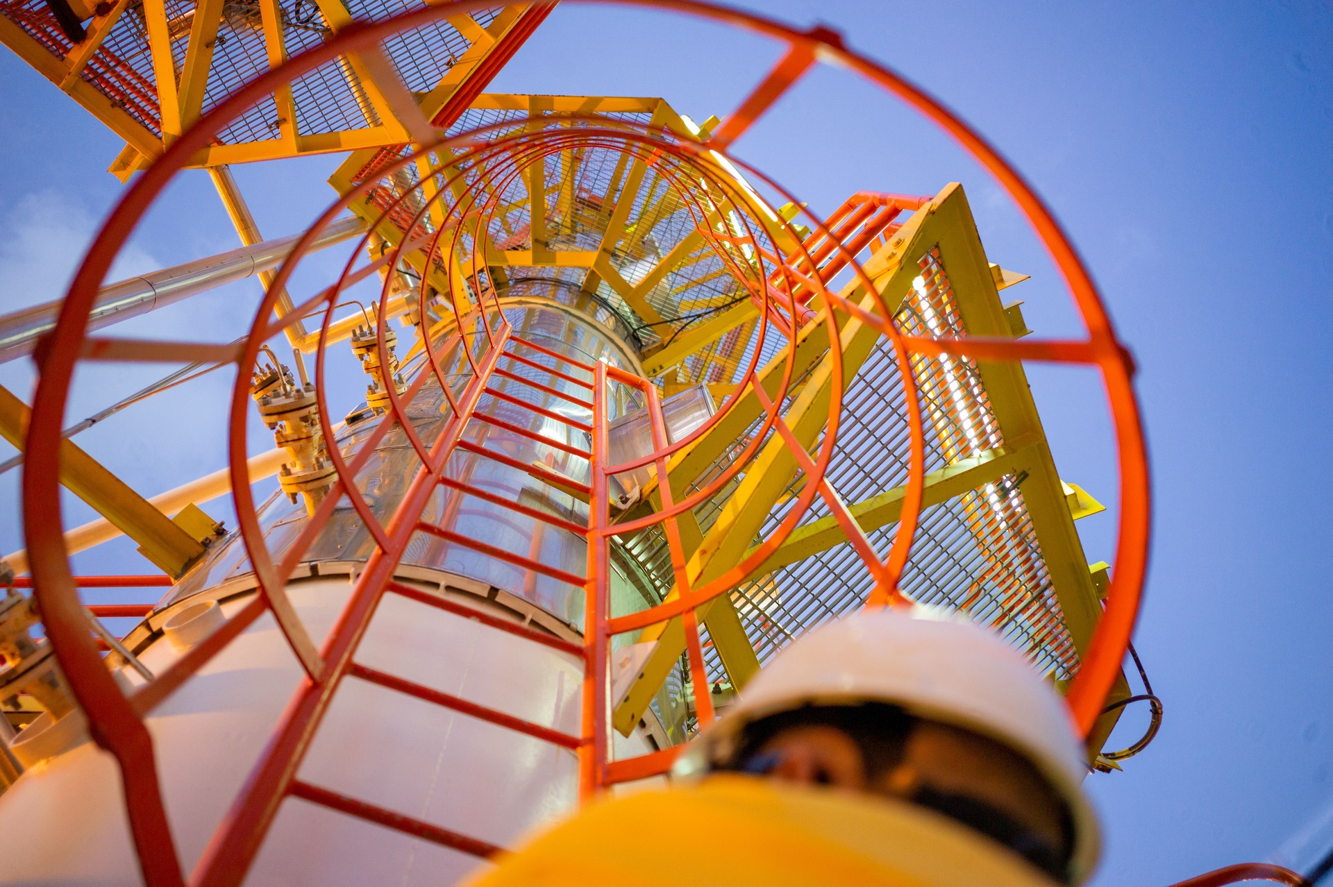 Oil Worker in Safety Cage Ladder Bottom up Pov